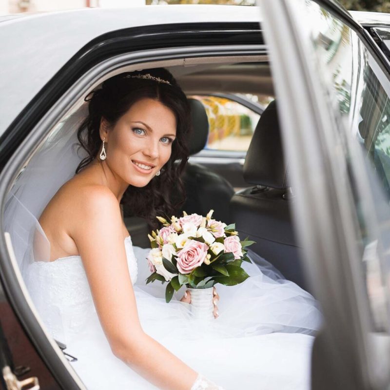 Young bride in a wedding car